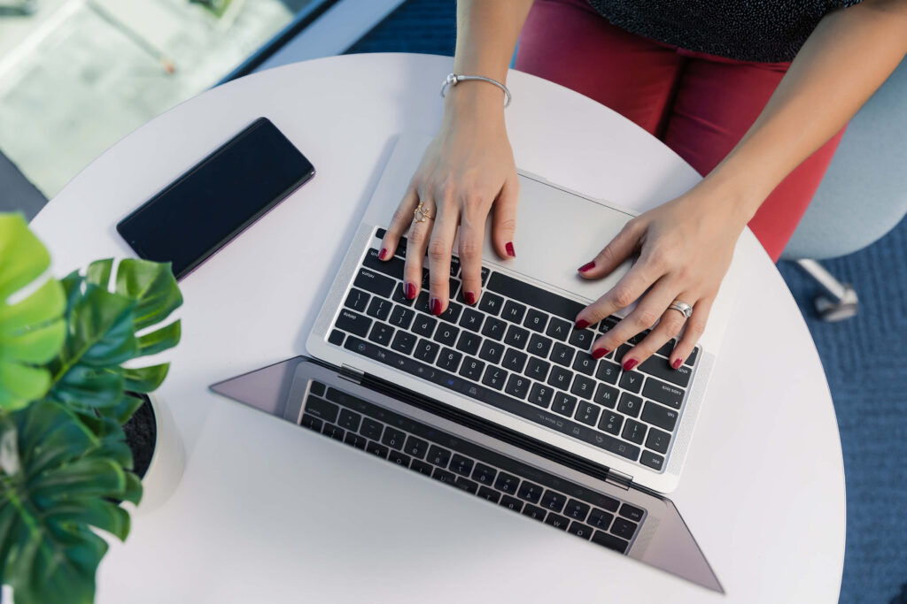 hands typing on a laptop